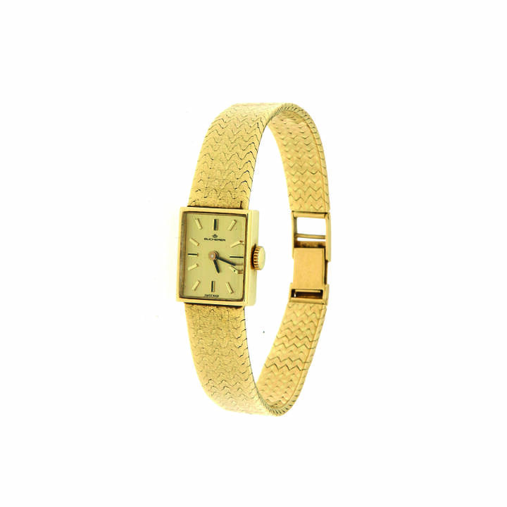 BUCHERER - Orologio gioiello anni '60<br>19x15<br>Cassa di forma in oro giallo con bracciale integrato lavorato a tessuto; quadrante con indici applicati Movimento a carica manuale
